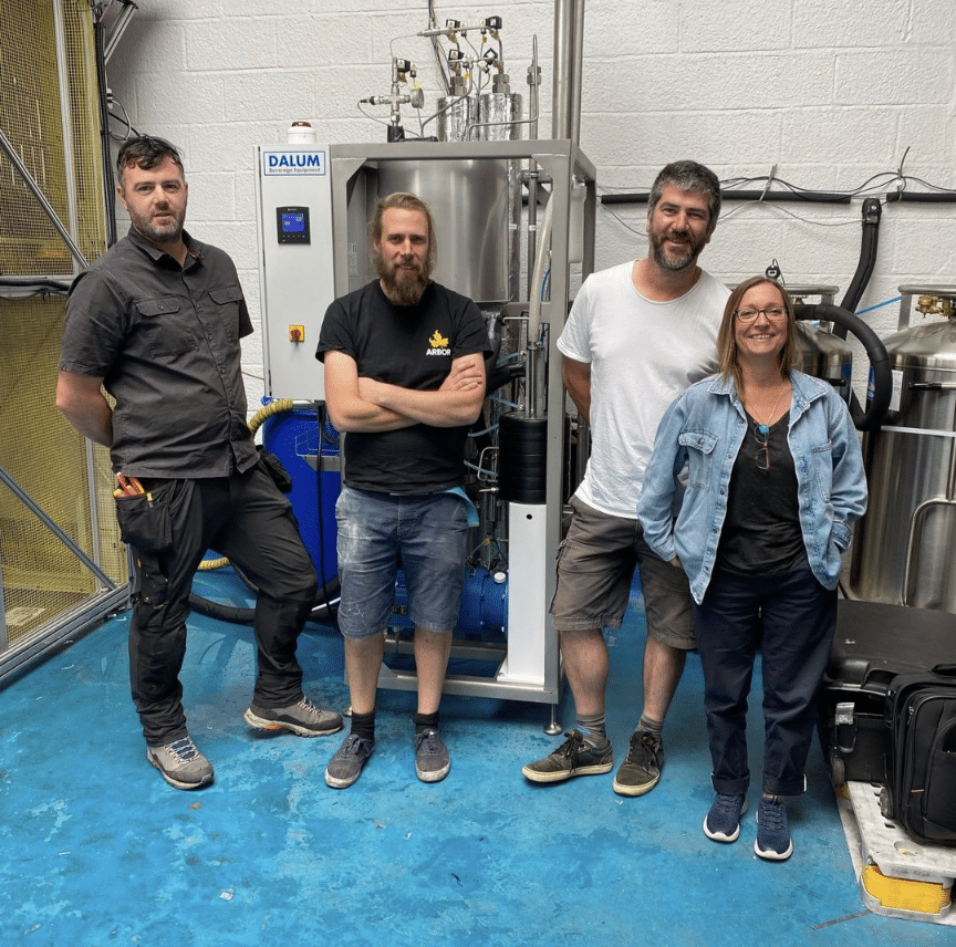 Four people from Arbor Ales standing in front of a DALUM CO2 Recovery Plant